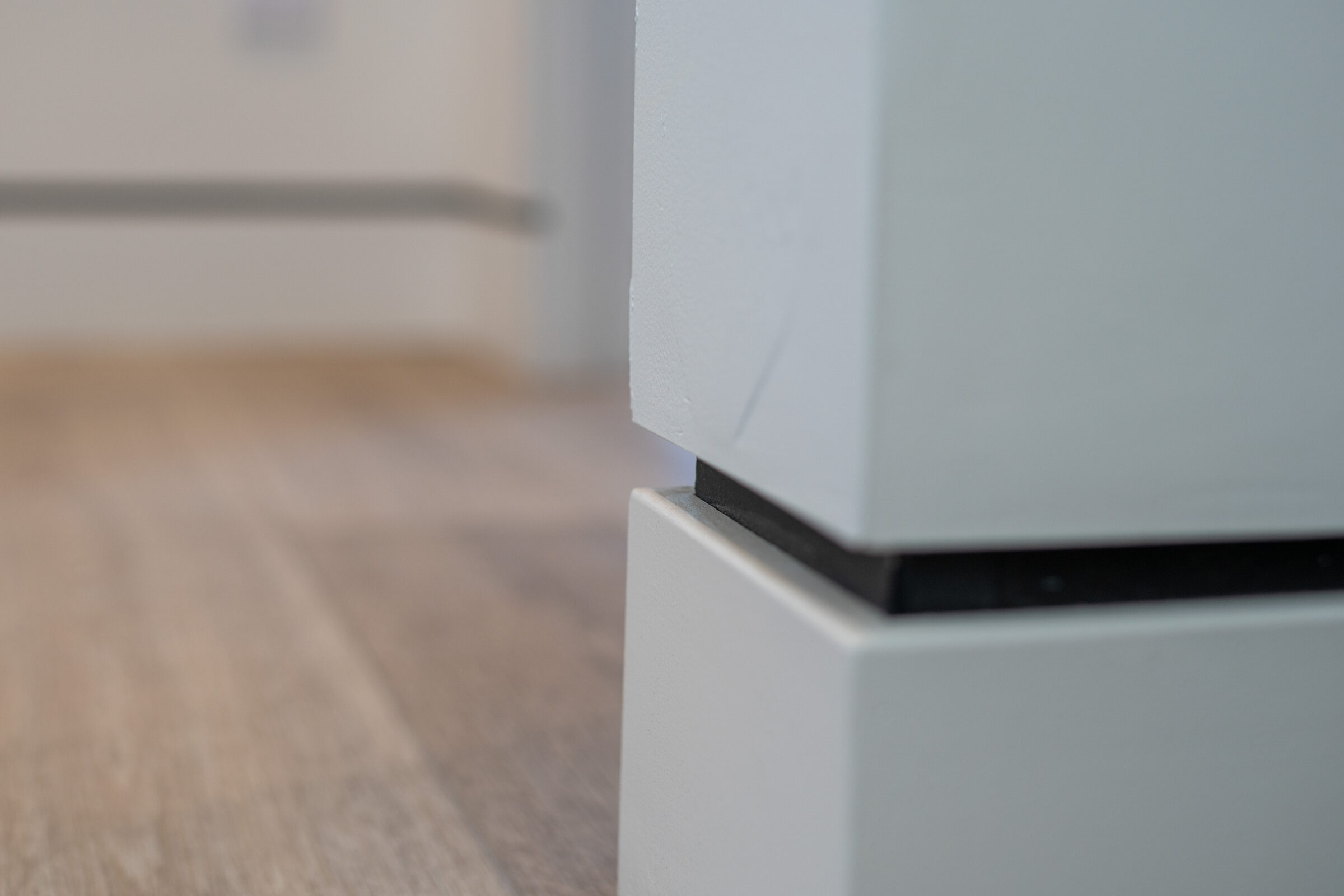 Detail of the waterfall-edge island and wide-plank wood floor