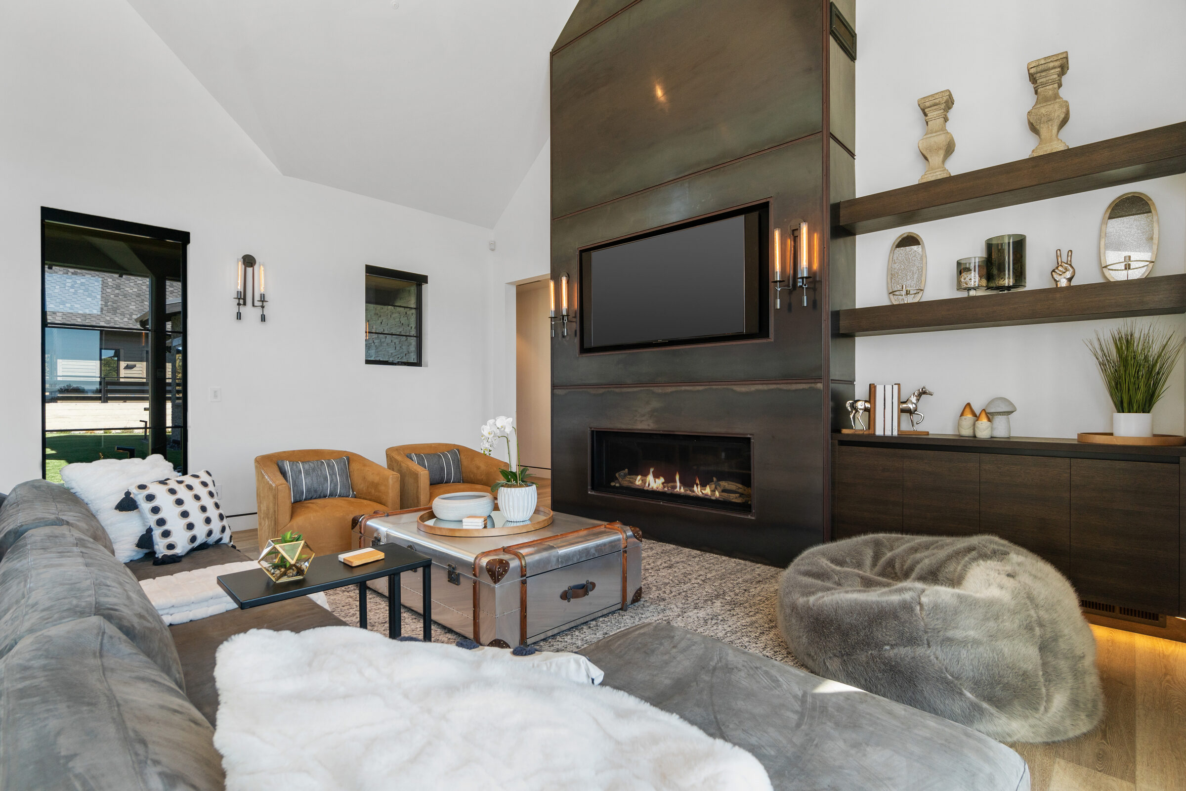 Living room with a linear fireplace and built-in shelving