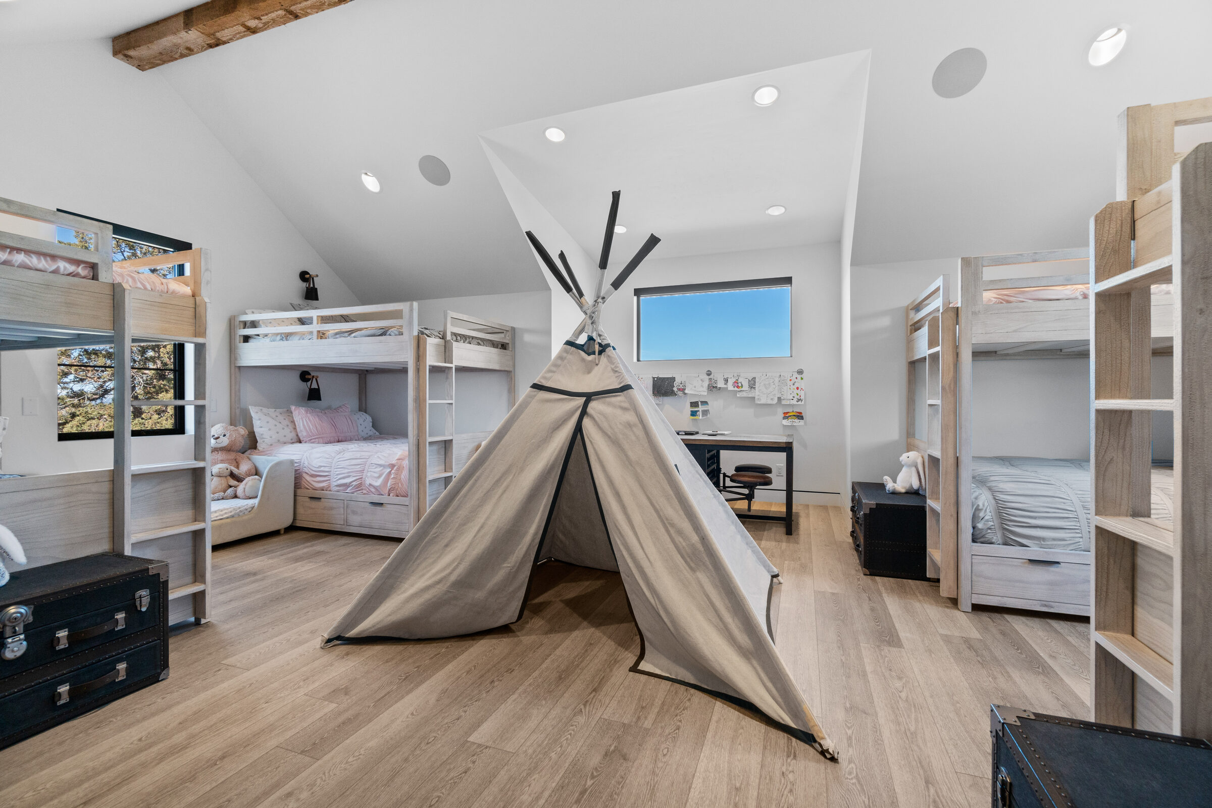 Children's bunk room with a vaulted ceiling