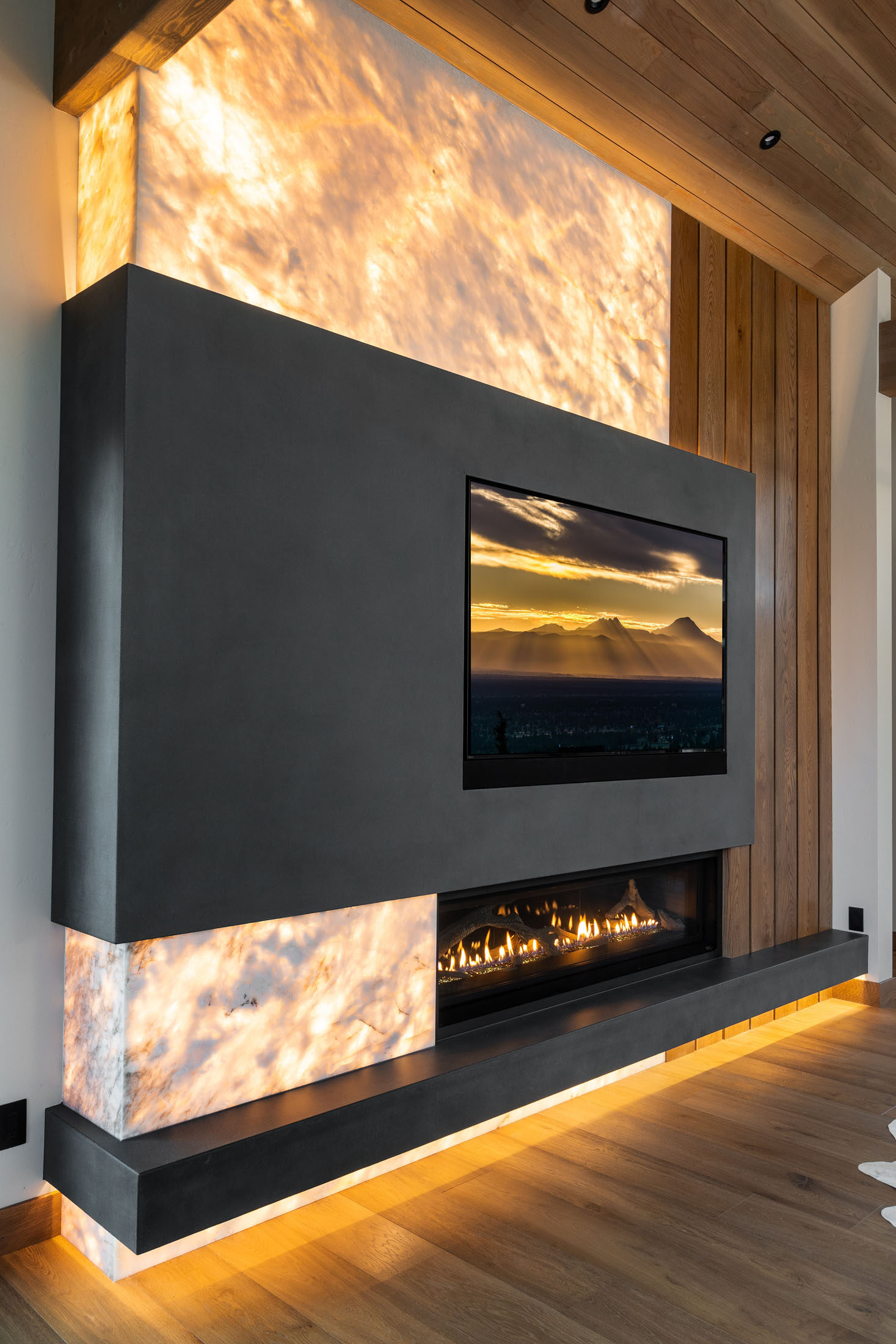 Great room with a backlit onyx fireplace wall and linear fire feature, Eagle Crest
