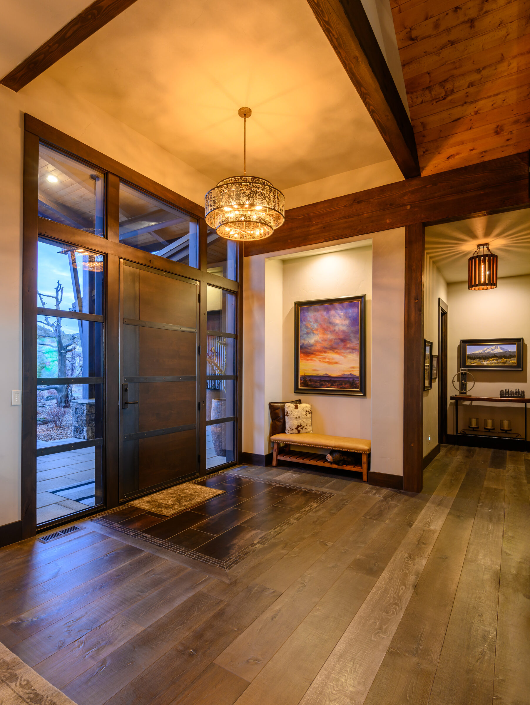 Entry foyer with a wood-clad ceiling and pendant light
