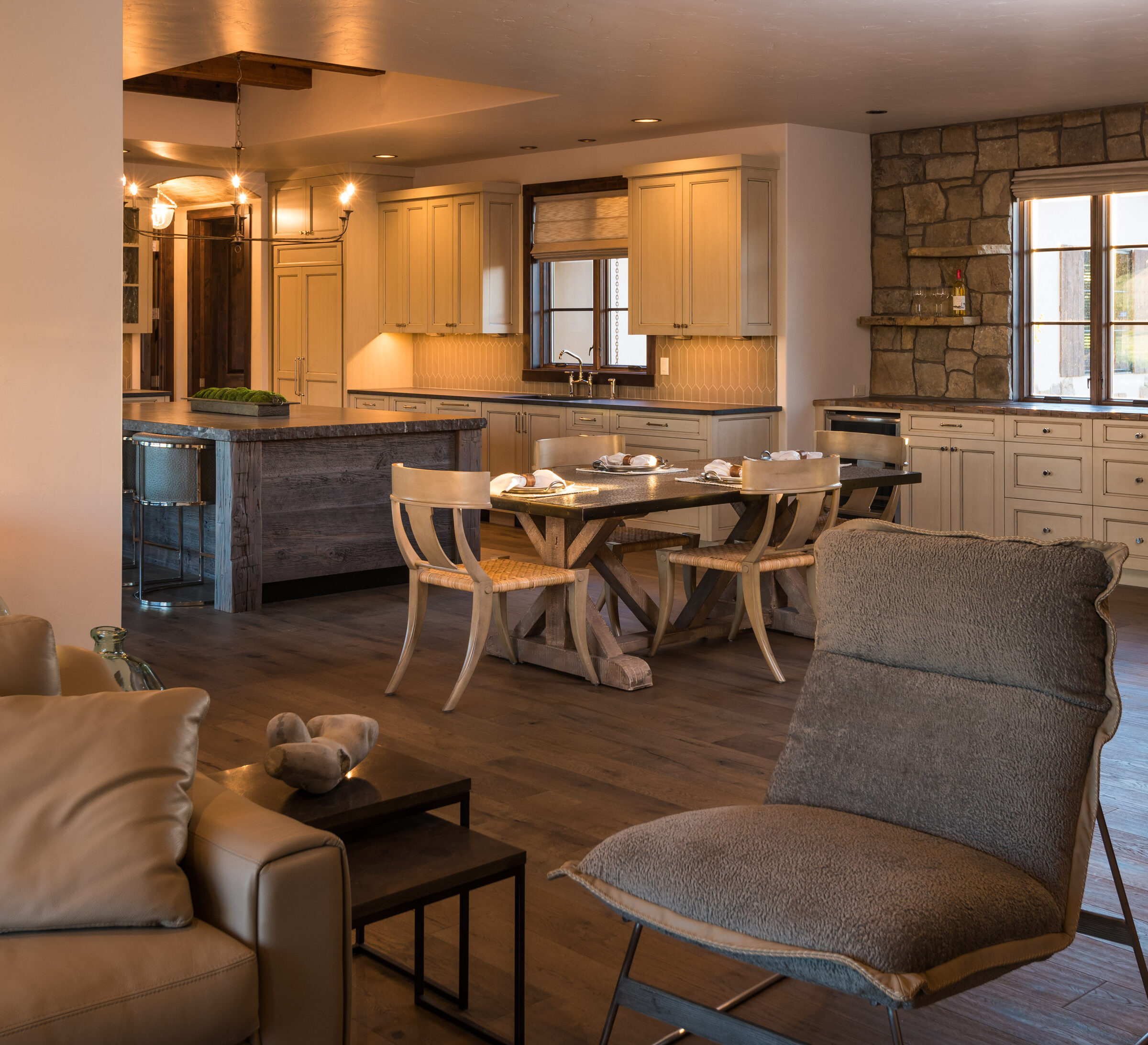 Open kitchen and dining with a round table and old-world stone accents