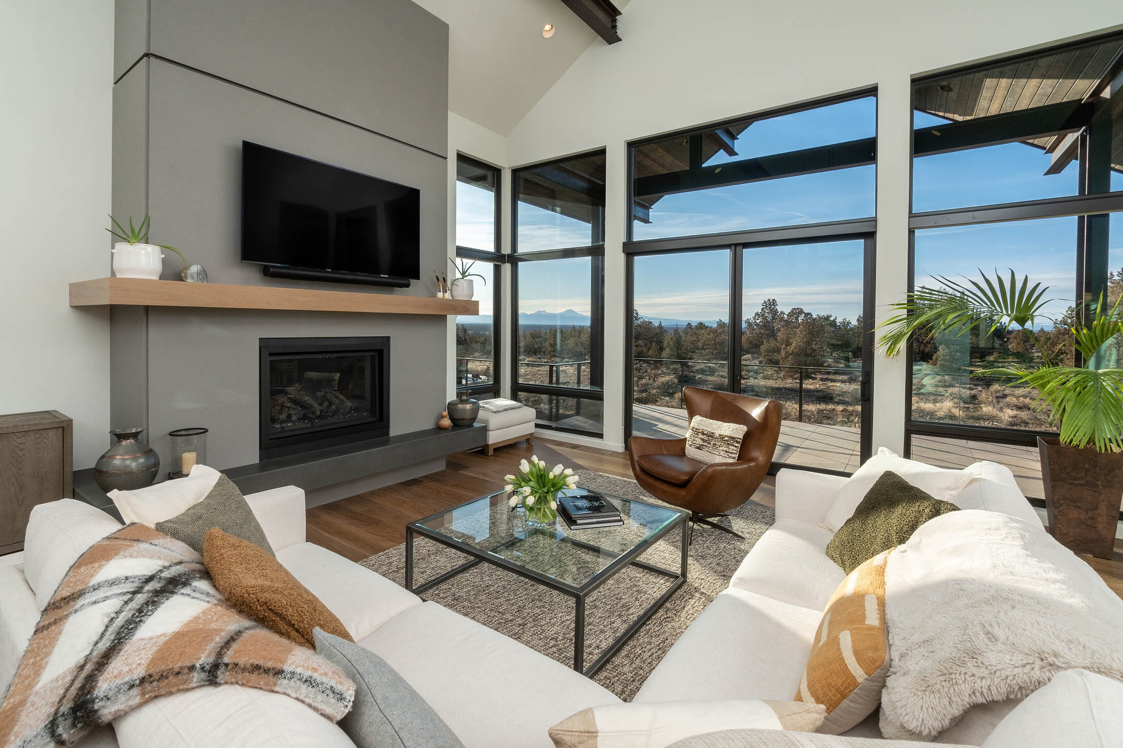 Starview great room with corner glass, fireplace, and high-desert views, Brasada Ranch, Powell Butte