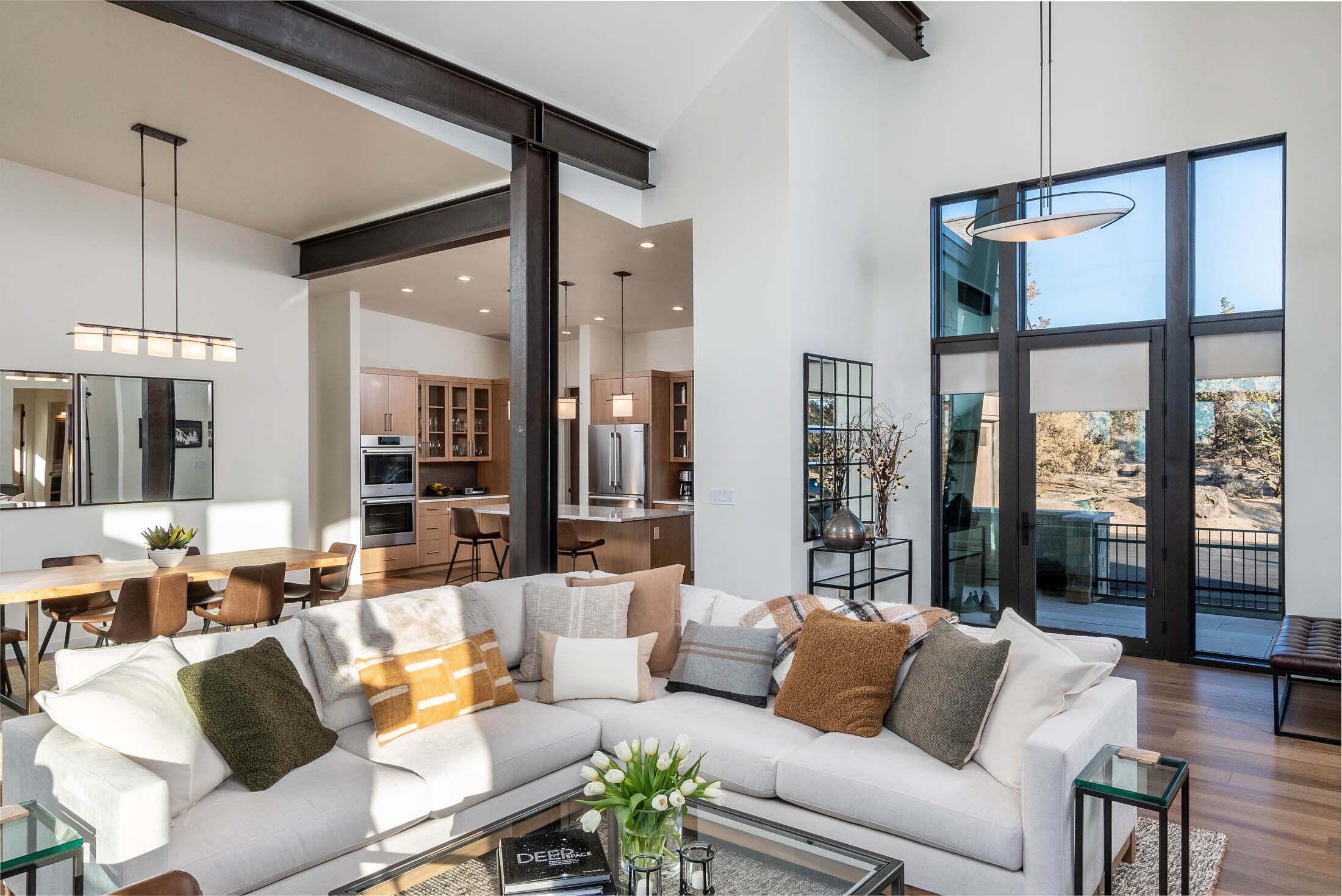 Starview open great room, dining, and kitchen under vaulted beamed ceilings, Brasada Ranch