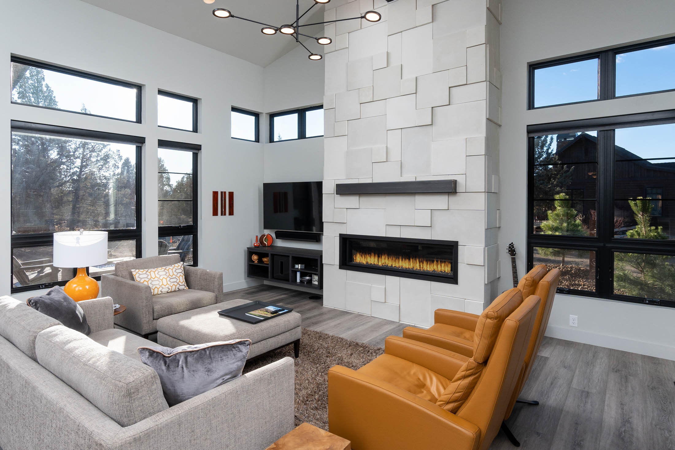 Wildhorse great room with white stacked-stone fireplace and walls of glass, Brasada Ranch, Powell Butte