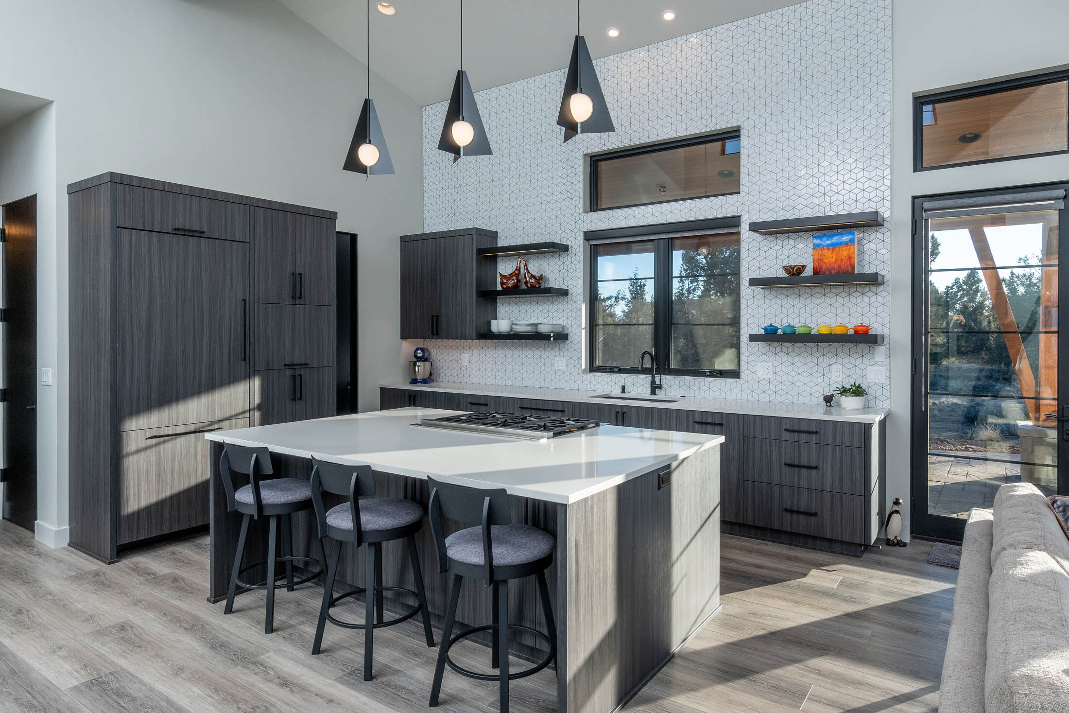 Wildhorse kitchen with waterfall-edge island and dark cabinetry, Brasada Ranch