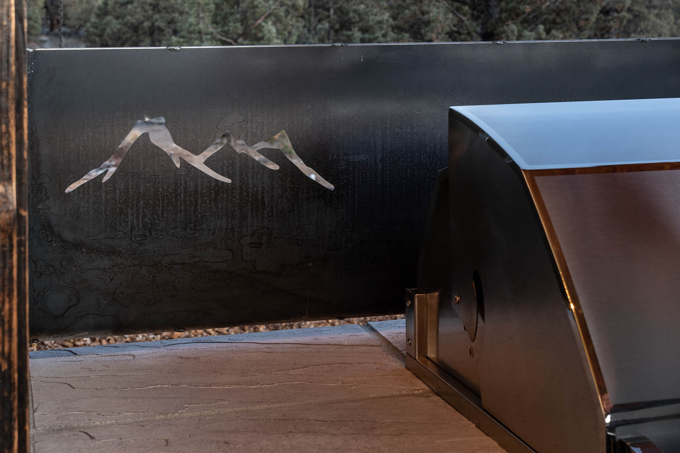 Wildhorse blackened-steel courtyard wall with cut mountain silhouette, Brasada Ranch